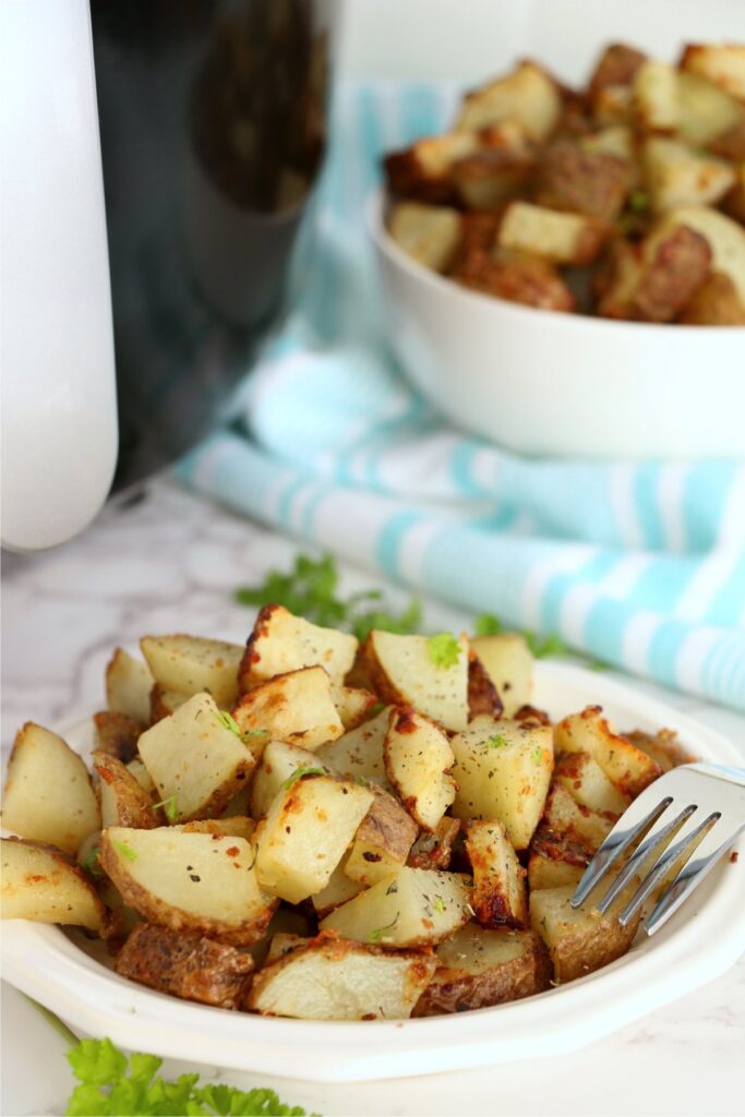 Closeup shot of air fryer garlic parmesan potatoes in bowl