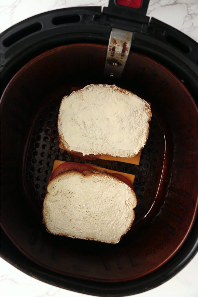 Overhead shot of two grilled cheese sandwiches in air fryer