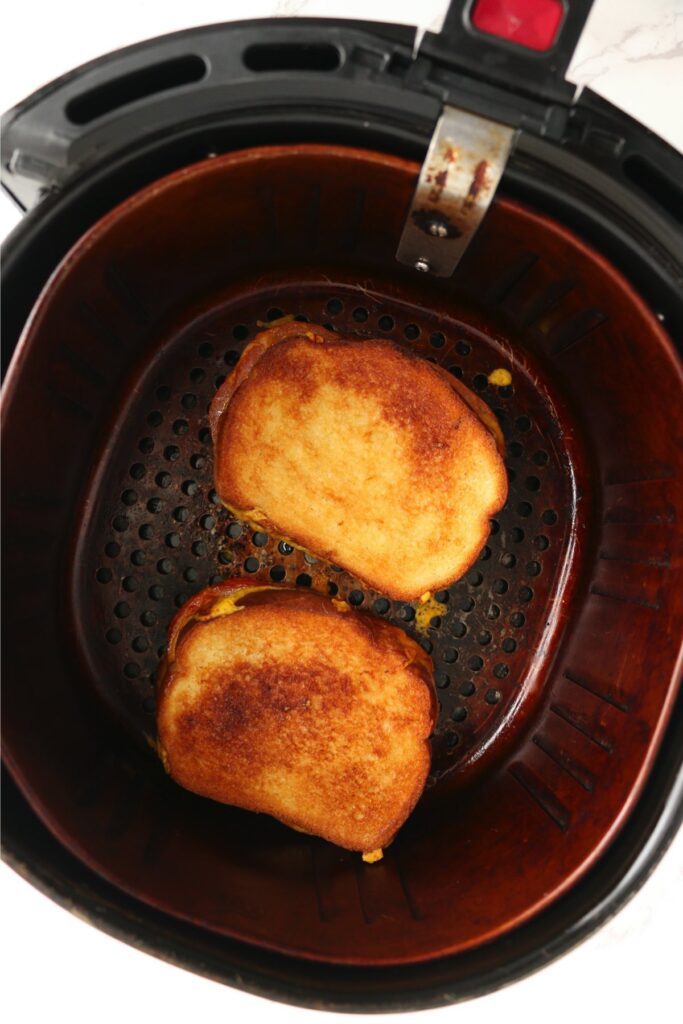 Overhead shot of cooked grilled cheese sandwiches in air fryer