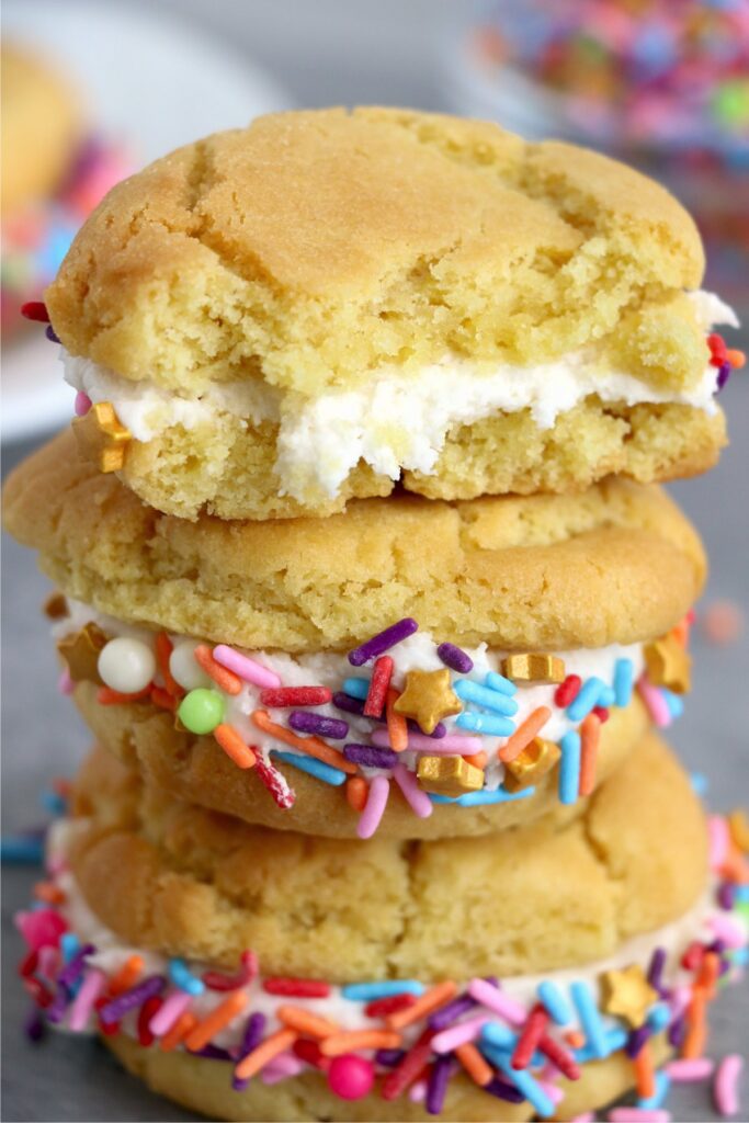 Three air fryer sugar cooke whoopie pies stacked atop one another