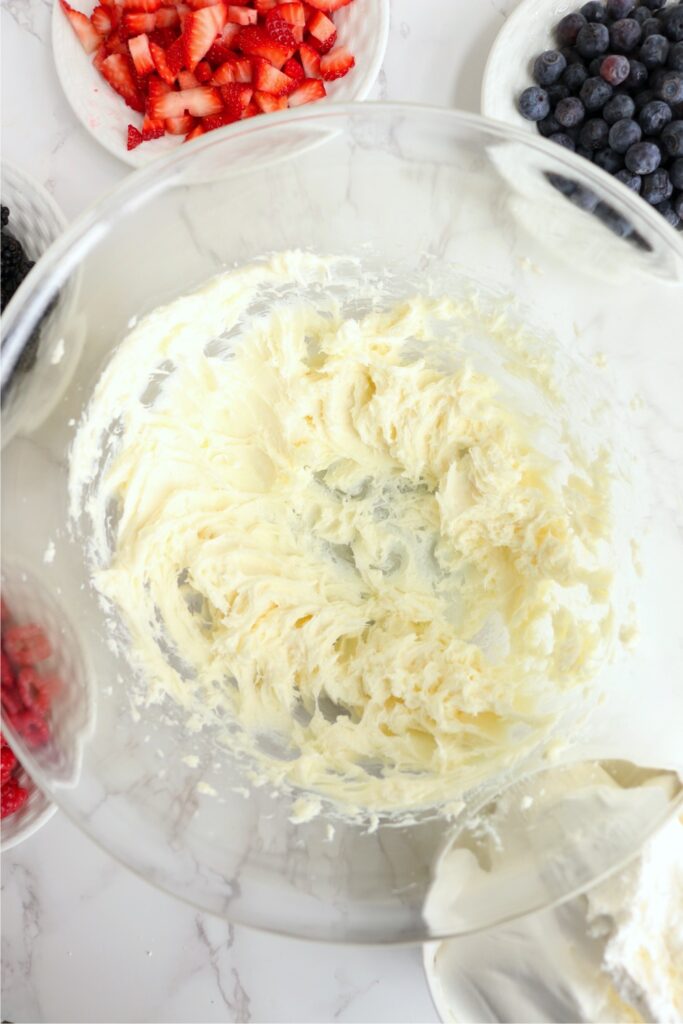 Oerhead shot of cream cheese and sugar creamed together in bowl