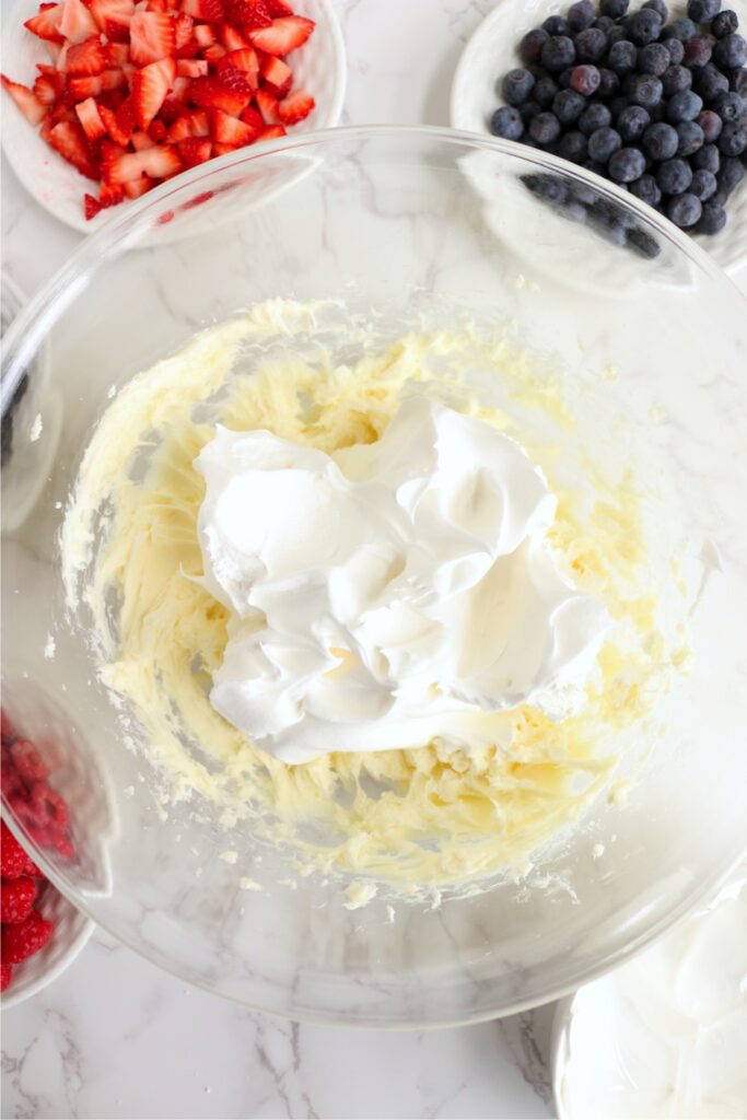 Cool whip with cream cheese and sugar in bowl