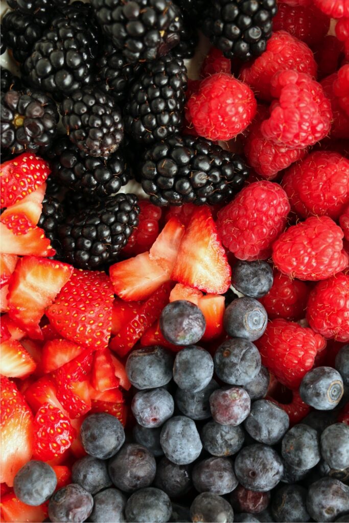 Overhead closeup shot of strawberries, blueberries, and blackberries