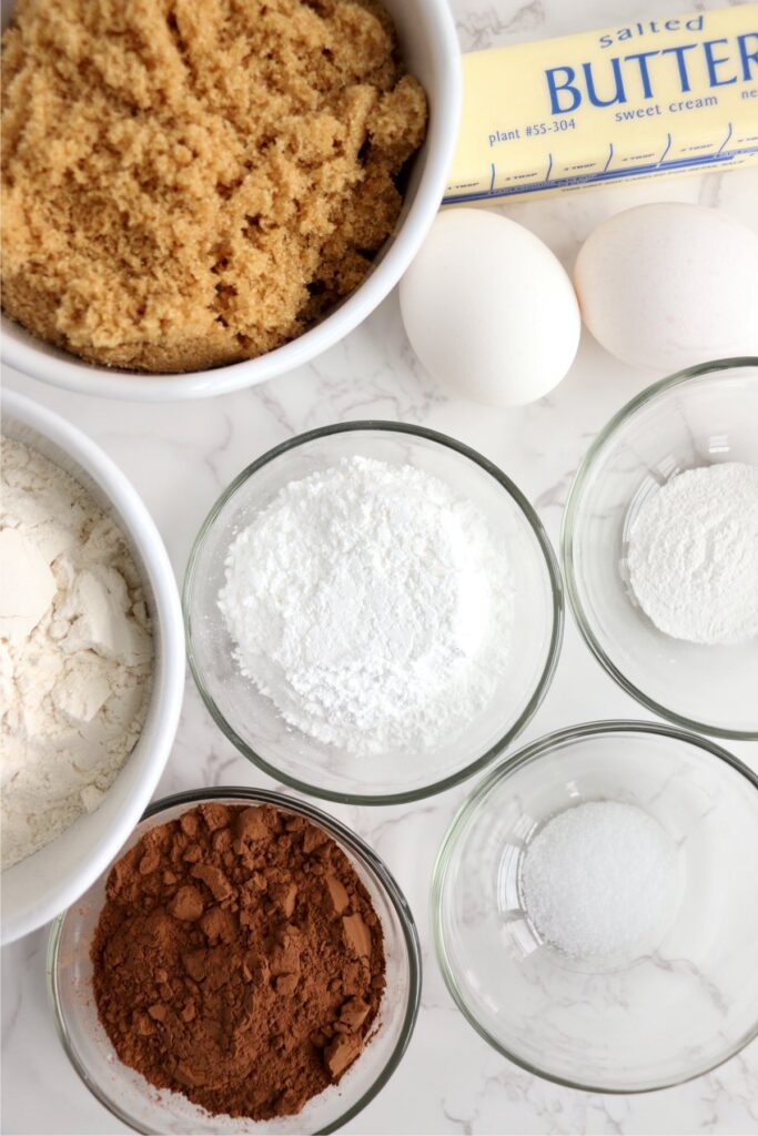 Overhead shot of chocolate crack cookie ingredients in indvidiual bowls on talbe