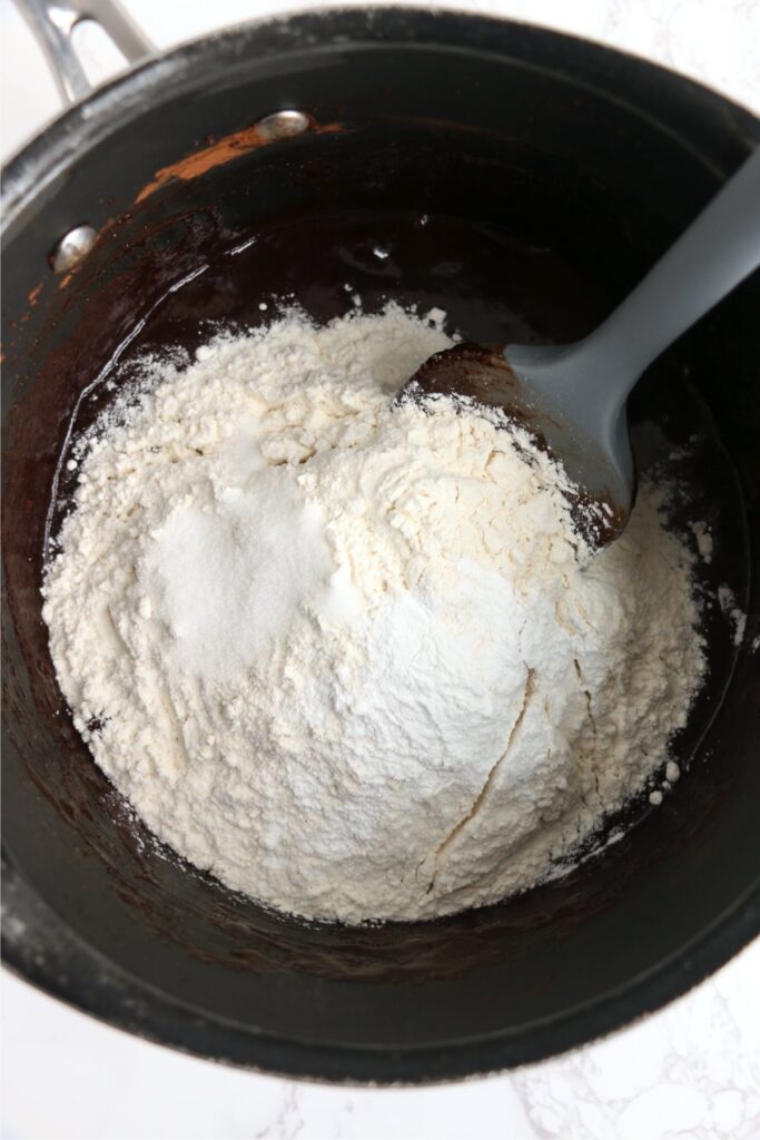 Flour, salt, and baking powder added to wet ingredients in saucepan