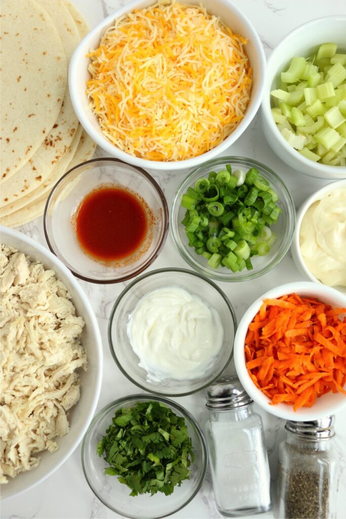 Overhead shot of individual wrap ingredients in bowls