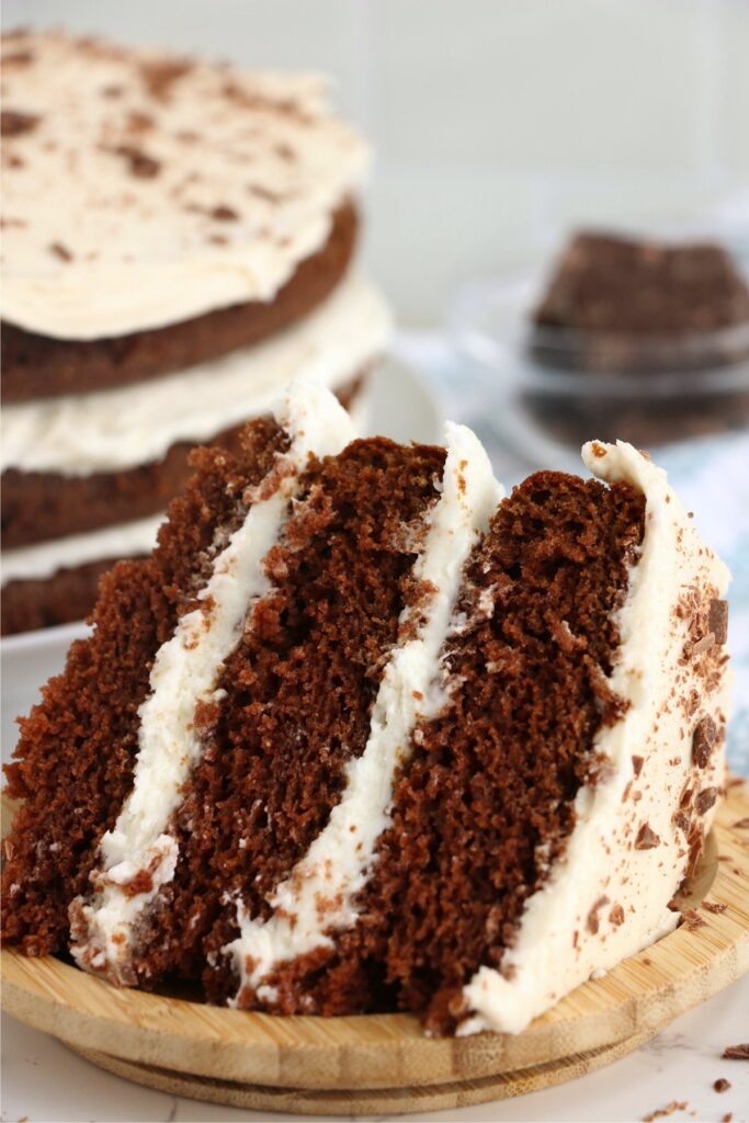 Slice of naked chocolate cake on plate