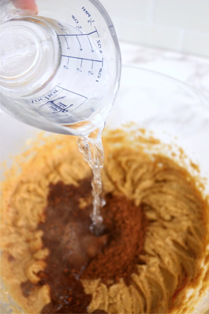 Boiling water being poured into batter