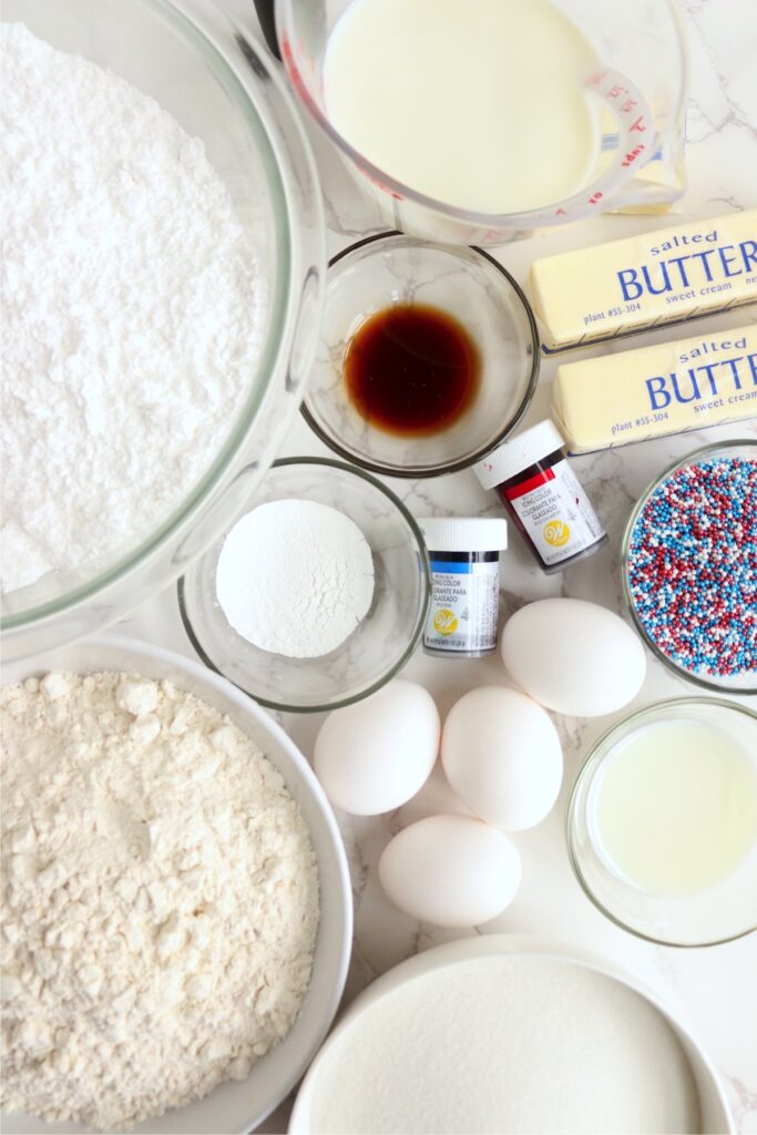 Overhead shot of individual cupcake and frosting ingredients in bowls