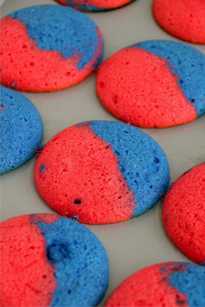 Closeup shot of baked red and blue-swirled cupcakes in cupcake tin