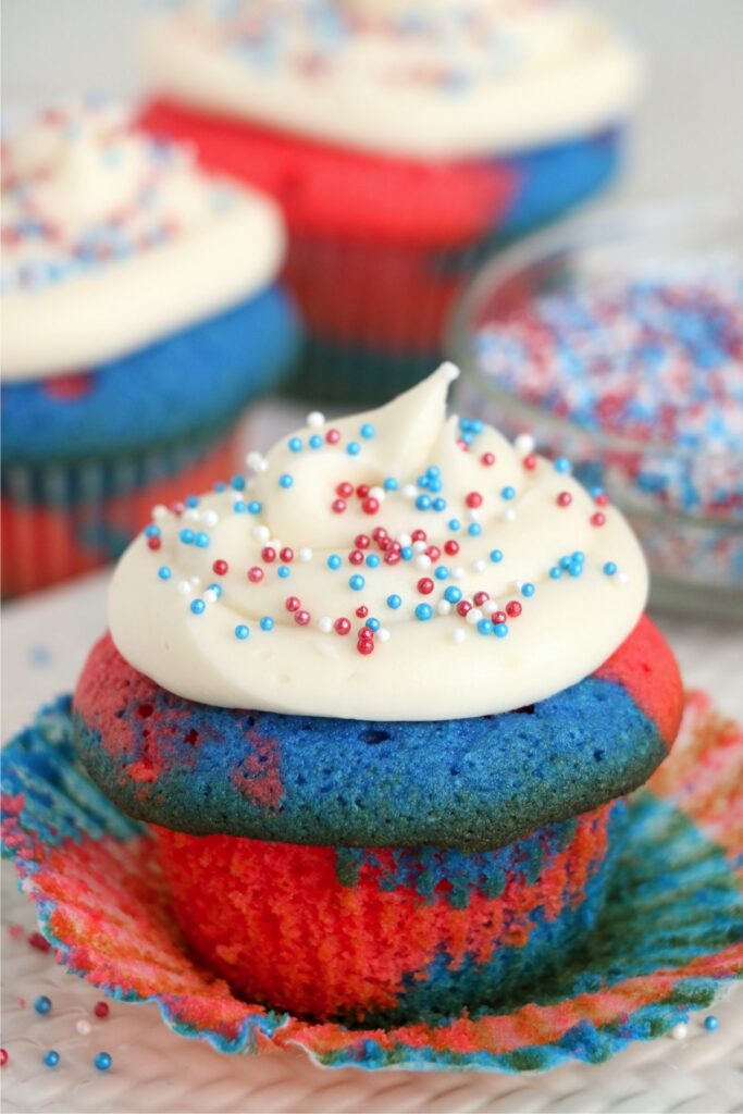 Red white and blue cupcake with more cupcakes in background