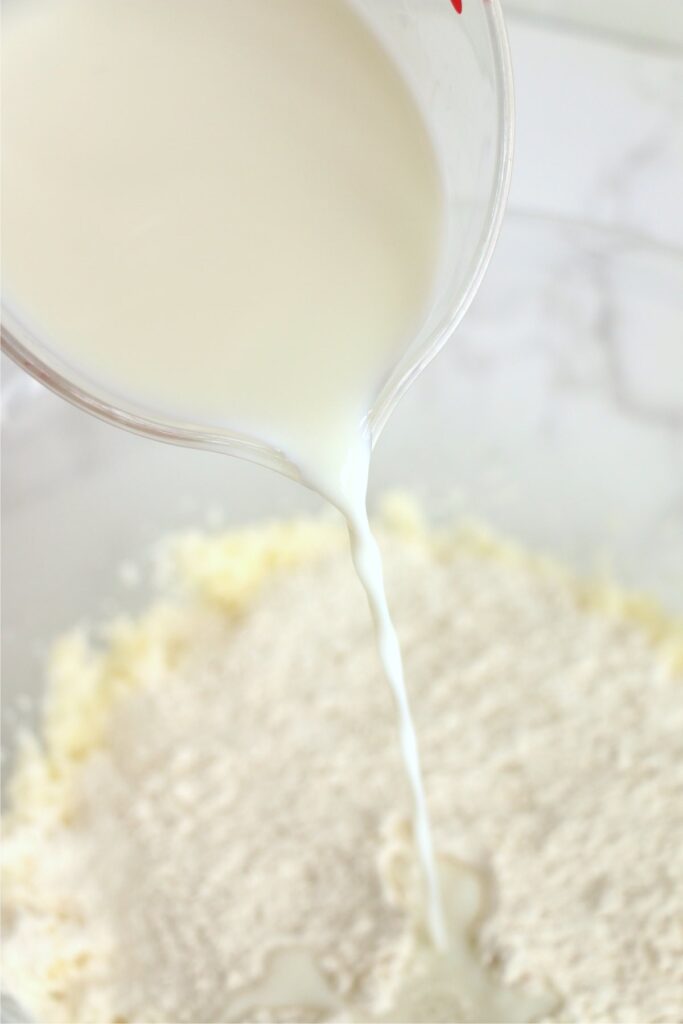 Milk being poured into flour mixture