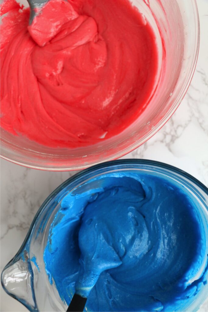 Overhead shot of red and blue batter in separate bowls