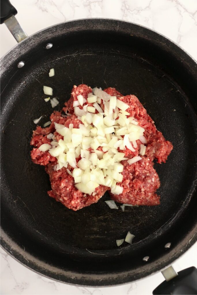 Overhead shot of beef and onions in skillet