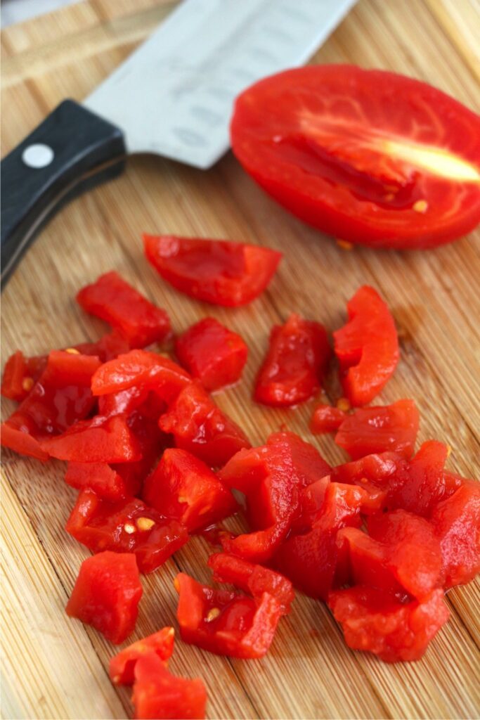 Closeup shot of diced tomatoes on cutting board