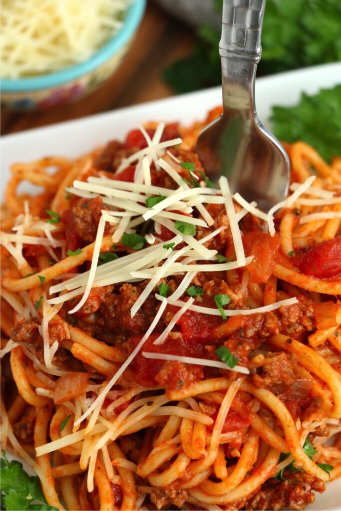  Closeup shot of school cafeteria spaghetti with fork in it