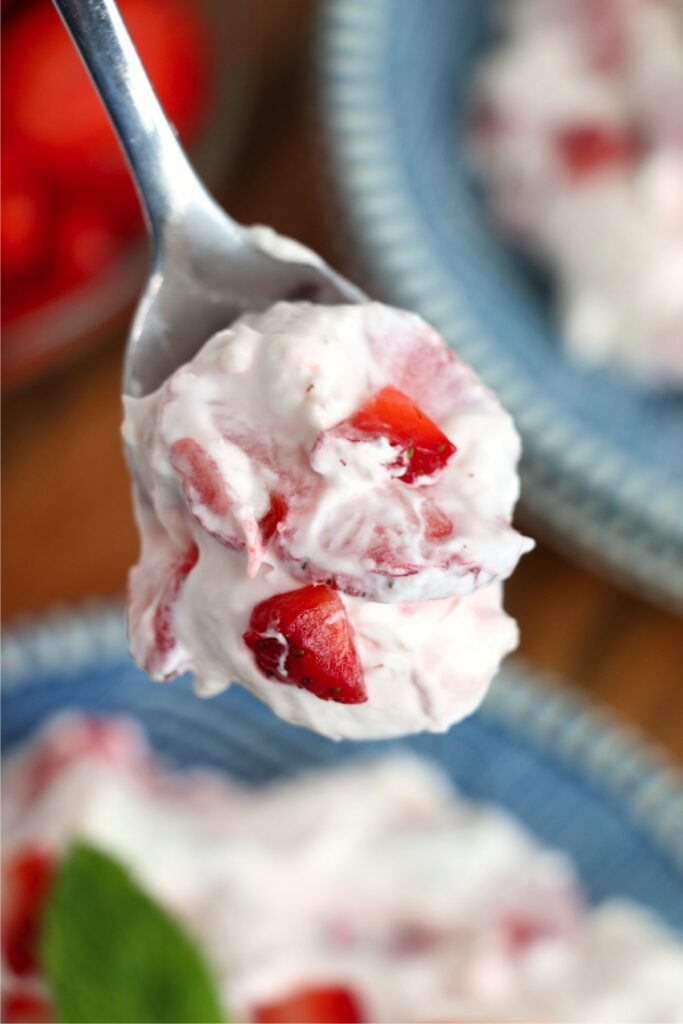 Closeup shot of spoonful of strawberry cheesecake salad