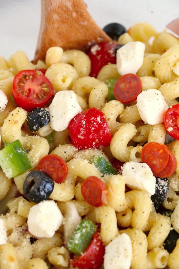 Closeup shot of spoon in finished summer pasta salad