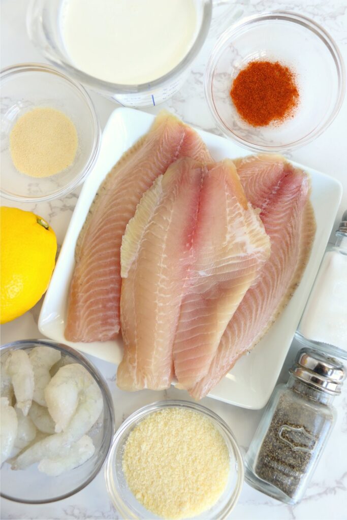 Overhead shot of individual tiliapia and shrimp ingredients on table