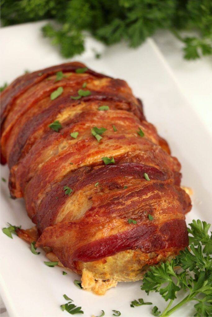 Bacon wrapped air fryer turkey meatloaf on serving plate