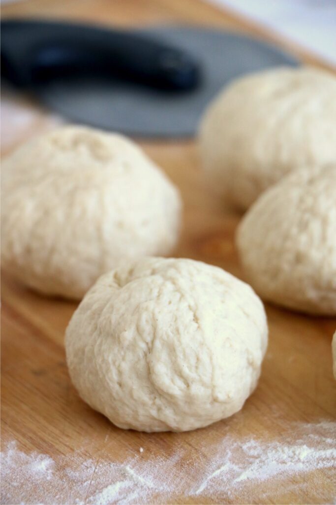 Rolls of flatbread dough on cutting board