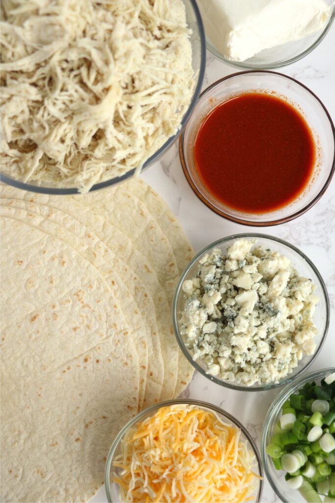 Overhead shot of Buffalo chicken wrap ingredients on table