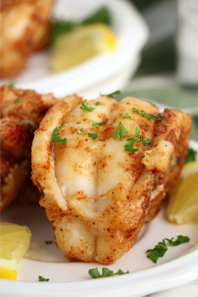 Closeup shot of butter poached lobster tails on plate