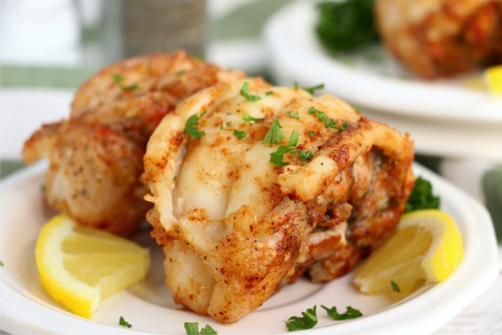 Closeup shot of butter poached lobster tails on plate