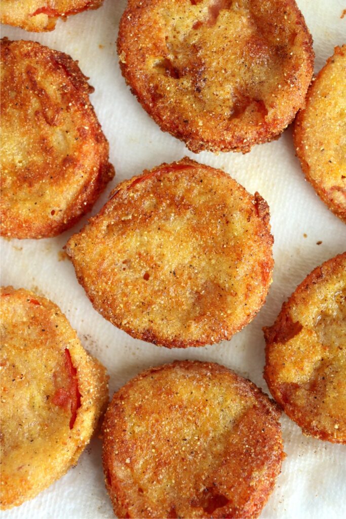 Closeup overhead shot of fried red tomatoes on paper towel