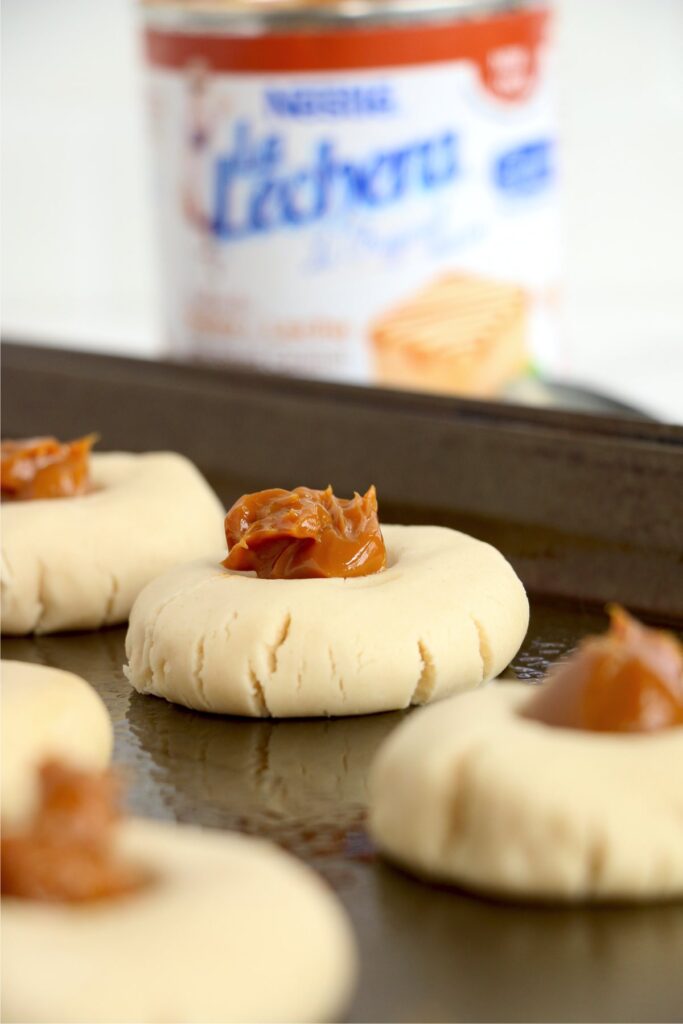 Closeup shot of uncooked dulce de leche cookies on baking sheet