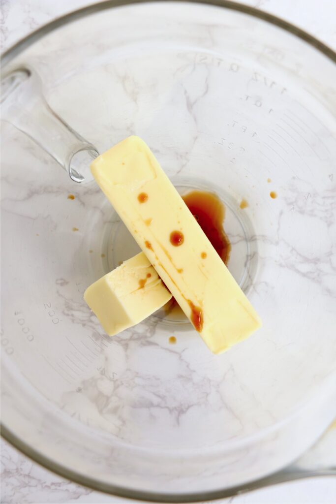 Overhead shot of butter sticks and vanilla in bowl