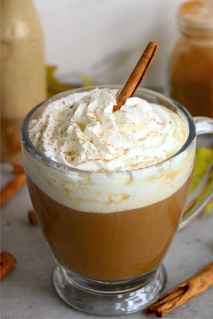 Mug filled with coffee and creamer topped with whipped cream