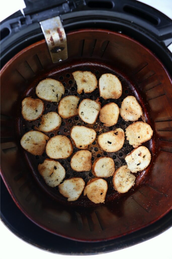 Overhead shot of air fryer bagel chips in air fryer basket