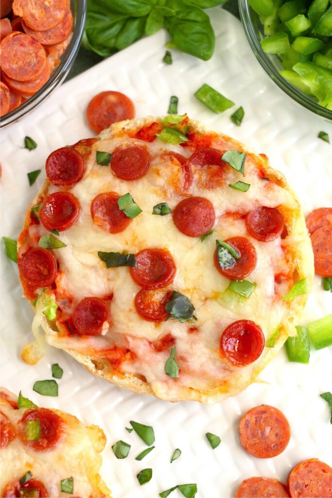 Overhead shot of air fryer English muffin pizza.
