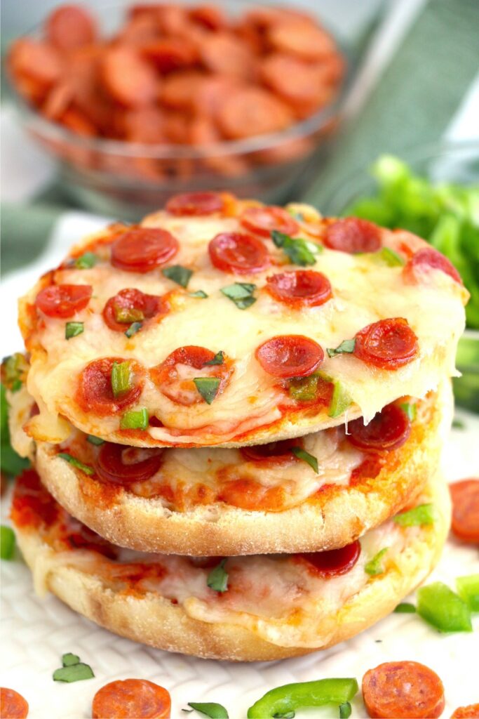 Three air fryer English muffin pizzas stacked atop one another.