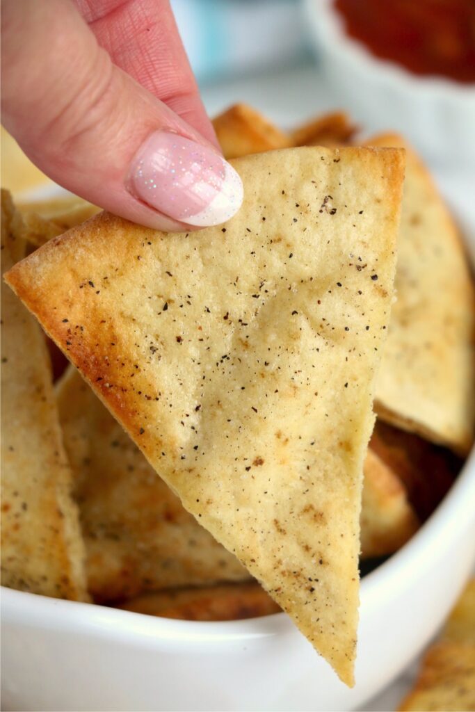 Closeup shot of hand holding air fryer pita chip