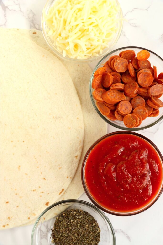 Overhead shot of individual pizza ingredients on table