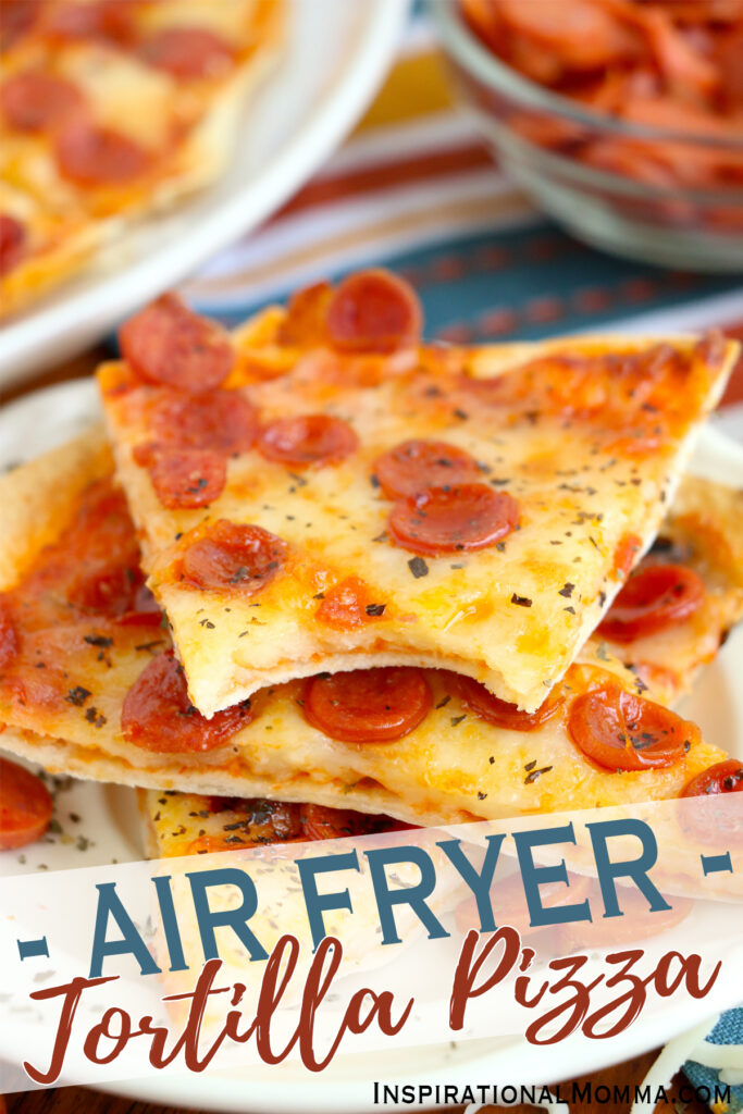 Closeup shot of air fryer tortilla pizza slices stacked atop one another with bite taken out of top slice