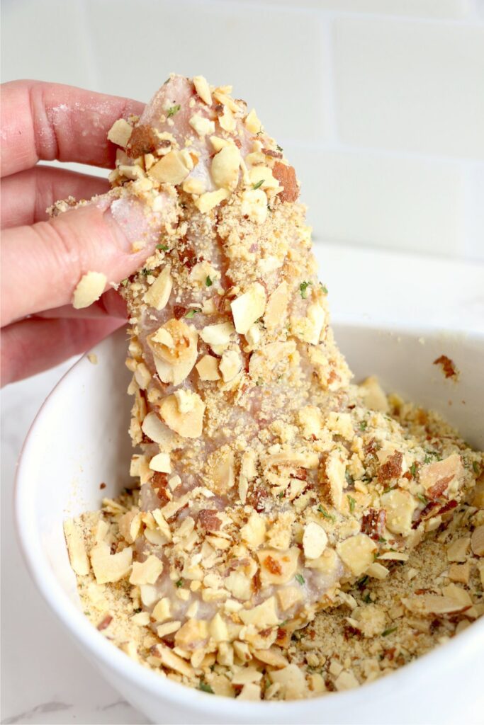 Walleye being coated in almond crust