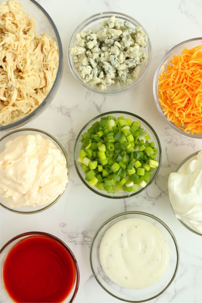 Overhead shot of dip ingredients in individual bowls on table