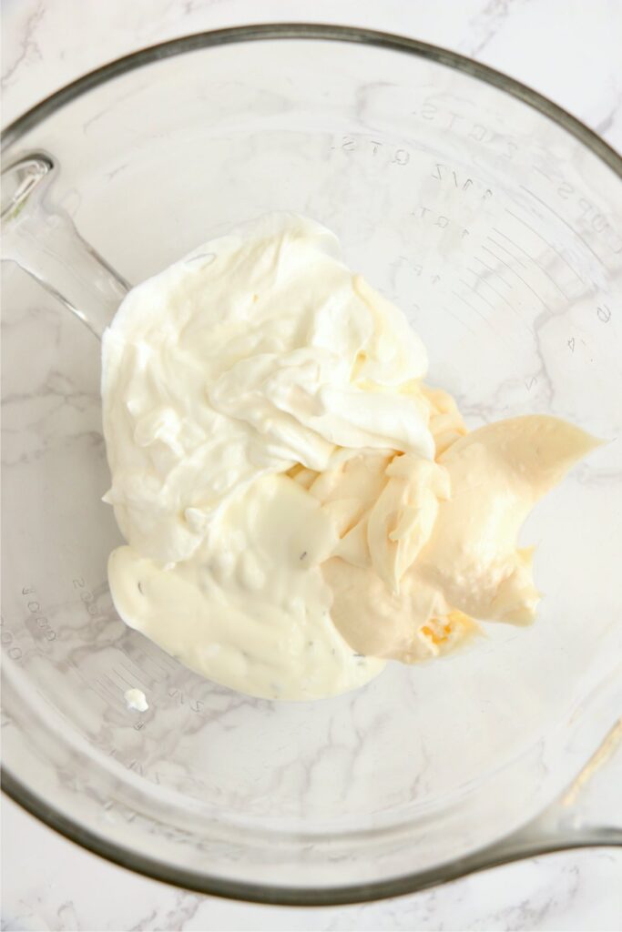 Overhead shot of mayo, sour cream, and ranch dressing in bowl