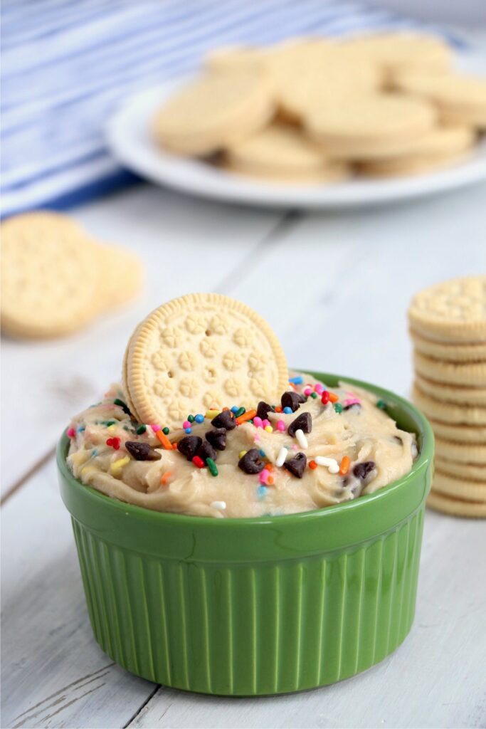 Cookie in bowlful of cookie dough dip.
