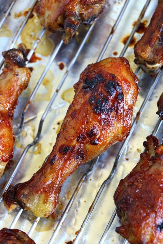 Closeup overhead shot of cooked crock pot bbq chicken drumnsticks on rack