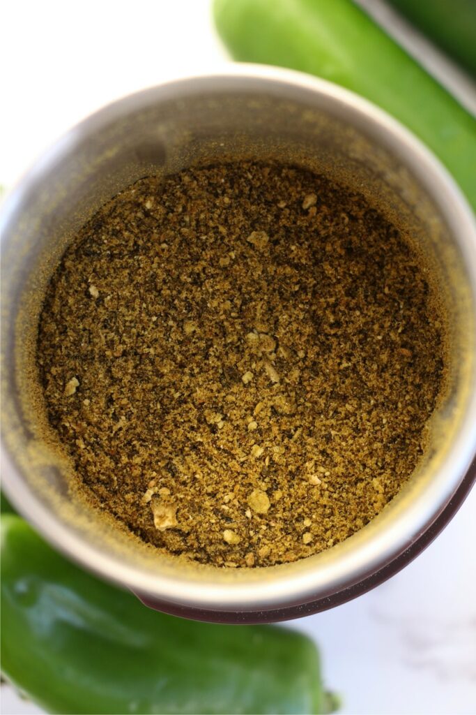 Overhead shot of spice grinder full of jalapeno powder