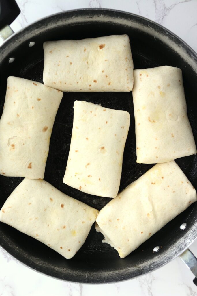 Overhead shot of chicken salsa wraps in pan 