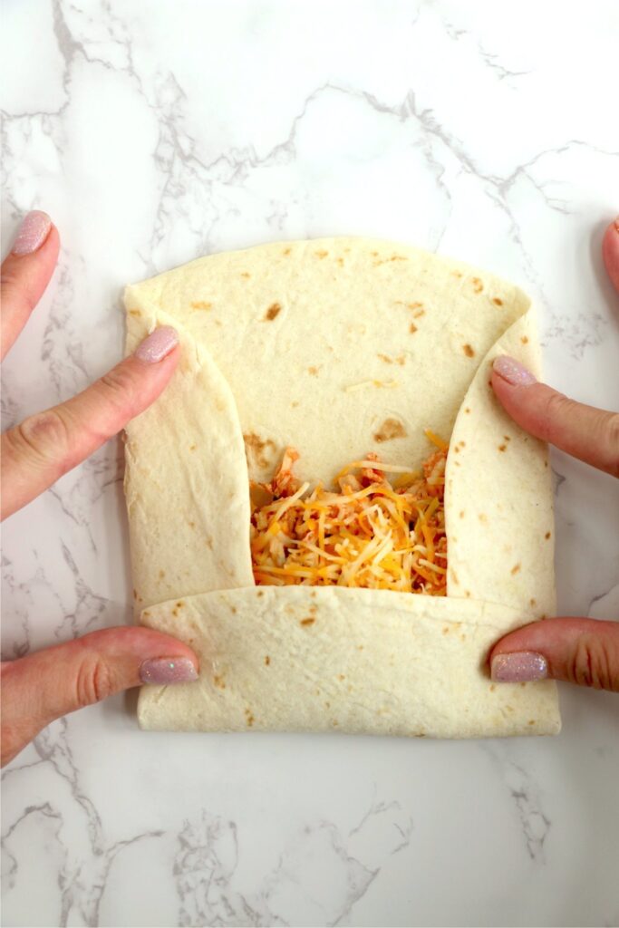 Overhead shot of folding up the tortillas