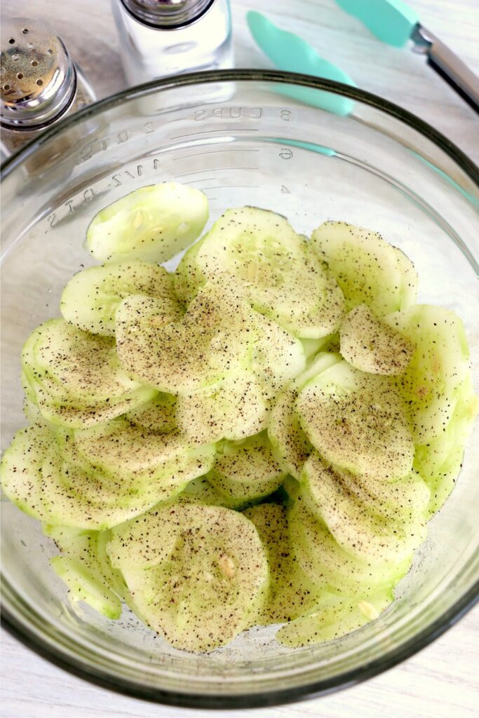 Overhead shot of cucumbers and seasoning in bowl