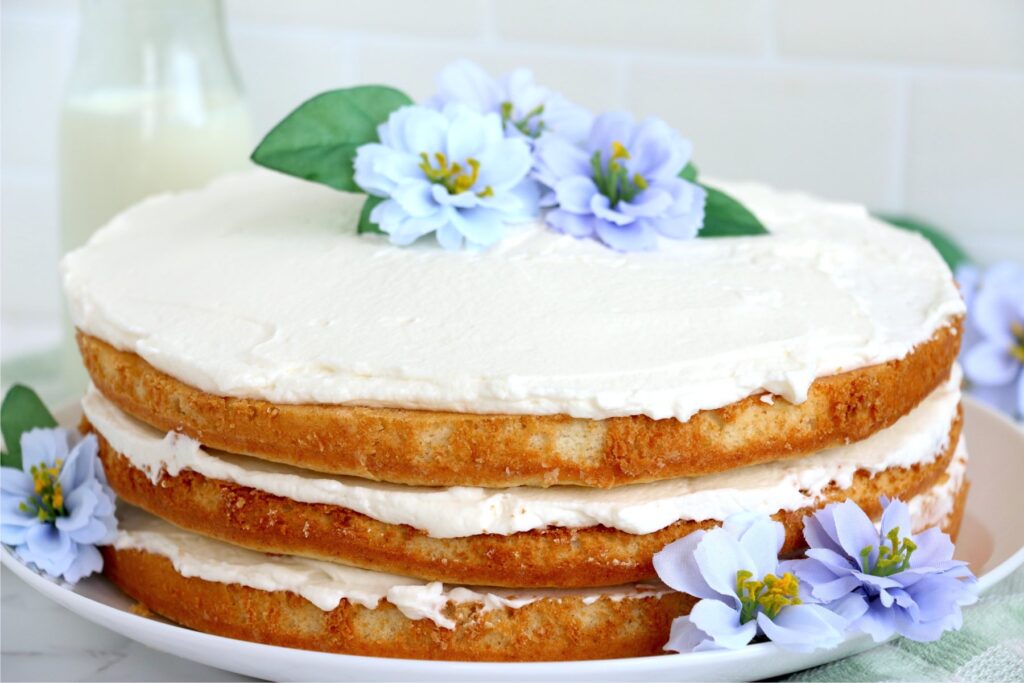 Naked flower cake on plate.