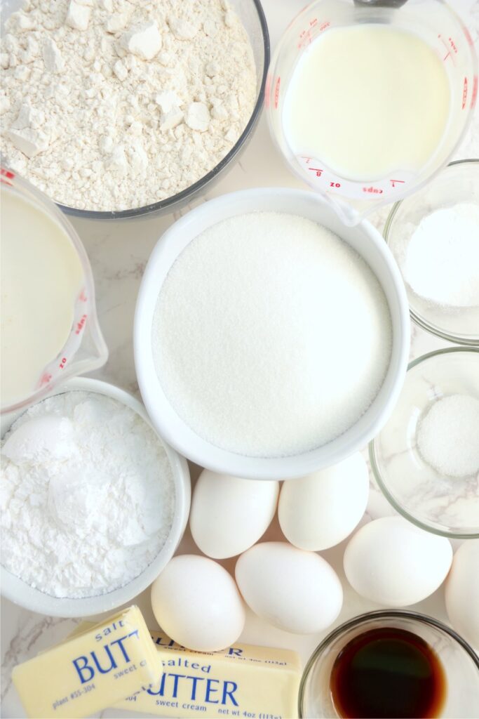 Overhead shot of cake and frosting ingredients in individual bowls