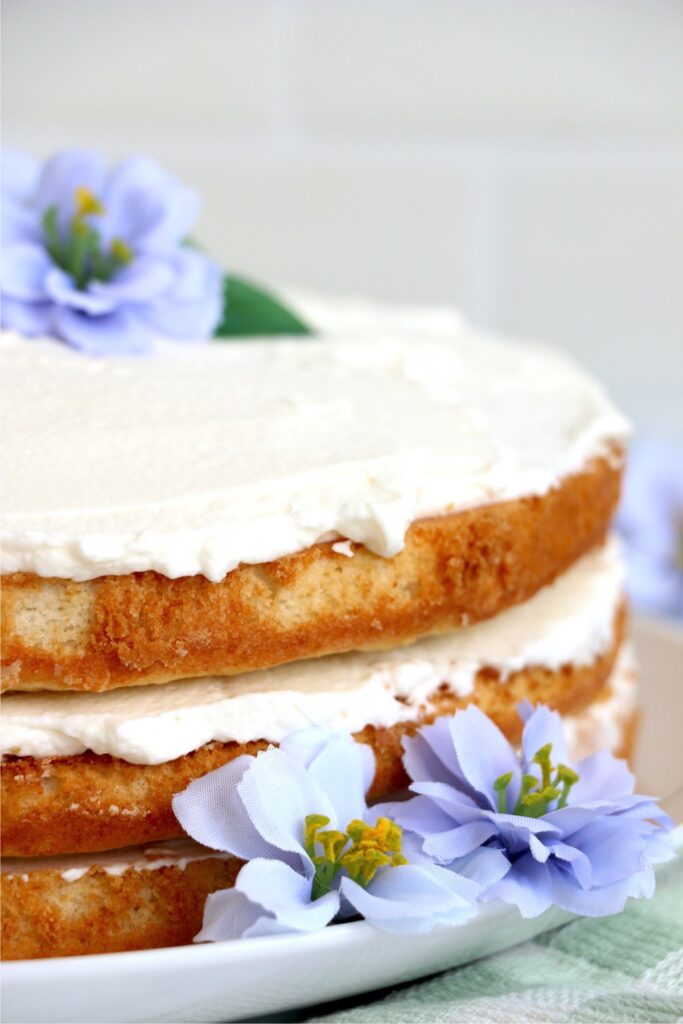 Closeup shot of naked flower cake decorated with flowers on plate